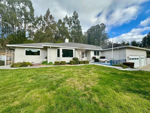 ranch-style home with a garage and a front lawn