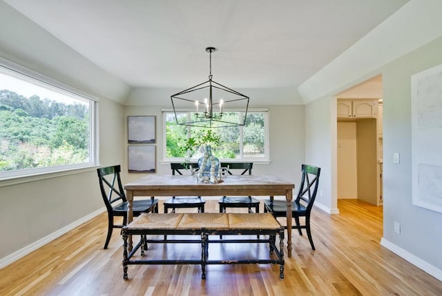 dining space with plenty of natural light, a notable chandelier, and light hardwood / wood-style floors