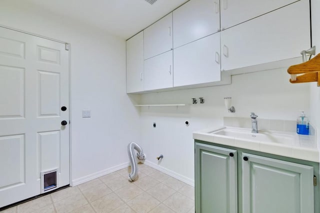 laundry room featuring gas dryer hookup, cabinets, hookup for an electric dryer, and sink