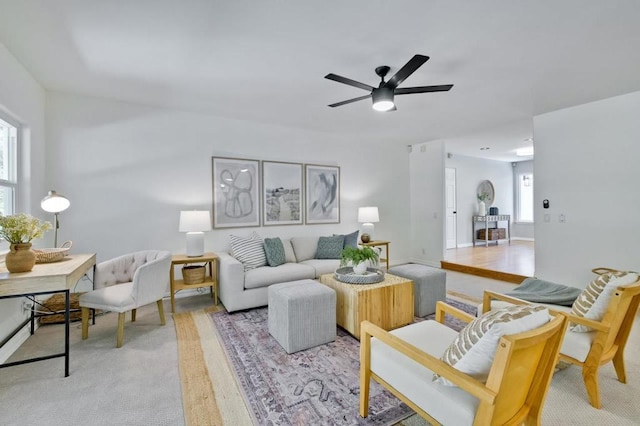 living room featuring ceiling fan and light hardwood / wood-style flooring