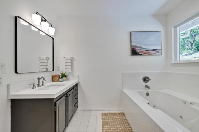 bathroom with tile patterned floors, vanity, and tiled tub