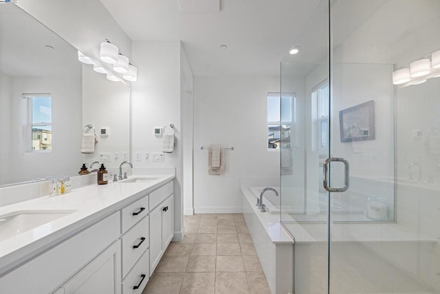 bathroom featuring tile patterned floors, independent shower and bath, vanity, and plenty of natural light