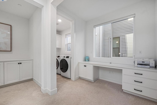 laundry room featuring cabinets, light colored carpet, and washing machine and dryer