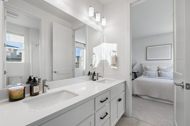 bathroom featuring tile patterned flooring, vanity, and toilet