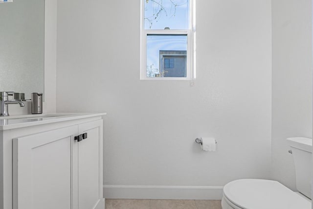 bathroom featuring vanity, tile patterned floors, and toilet