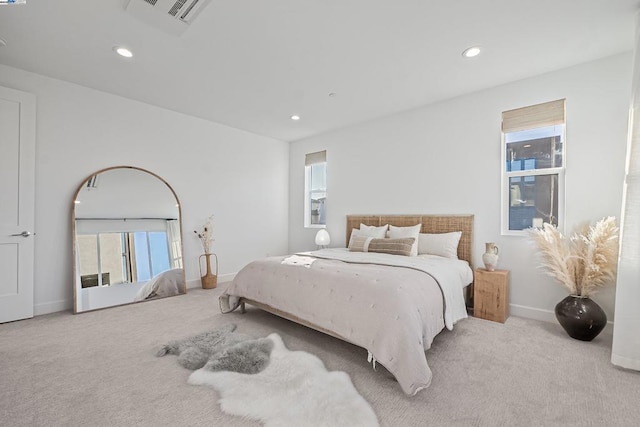 carpeted bedroom with multiple windows