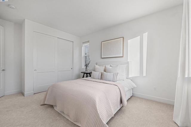 carpeted bedroom with a closet