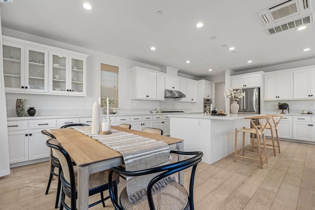 dining room featuring sink and light hardwood / wood-style flooring