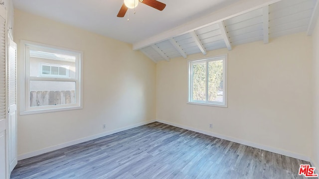 spare room featuring vaulted ceiling with beams, hardwood / wood-style flooring, and ceiling fan