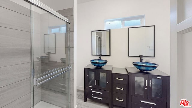 bathroom featuring vanity, a shower with door, and hardwood / wood-style floors