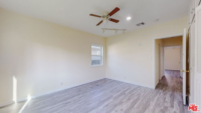 empty room with ceiling fan and light wood-type flooring