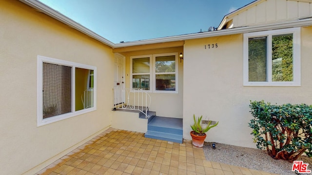 property entrance featuring a patio