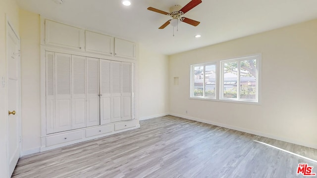 unfurnished bedroom featuring a closet, ceiling fan, and light wood-type flooring