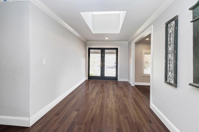 doorway with dark hardwood / wood-style flooring, a skylight, ornamental molding, and french doors