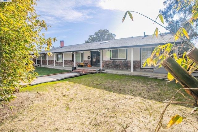 single story home with a playground and a front lawn