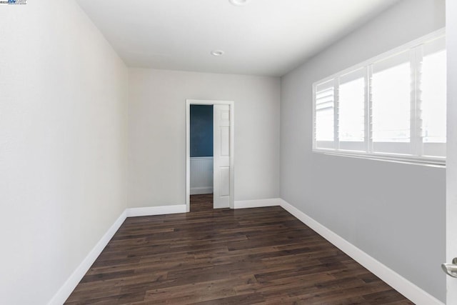 spare room featuring dark wood-type flooring