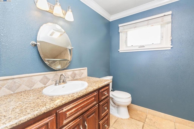 bathroom with vanity, crown molding, and toilet