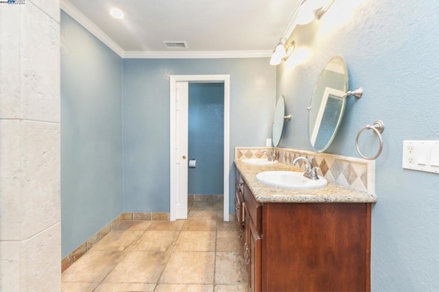 bathroom with ornamental molding and vanity