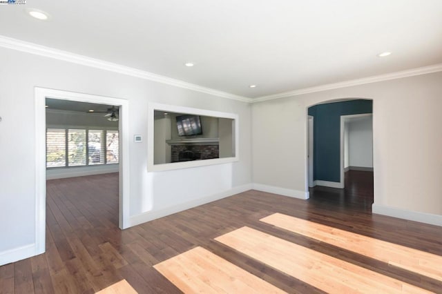 unfurnished living room featuring crown molding and dark hardwood / wood-style flooring