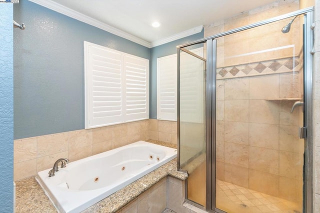 bathroom featuring ornamental molding and separate shower and tub