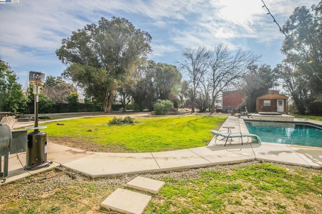 exterior space with an outbuilding, a yard, and a patio