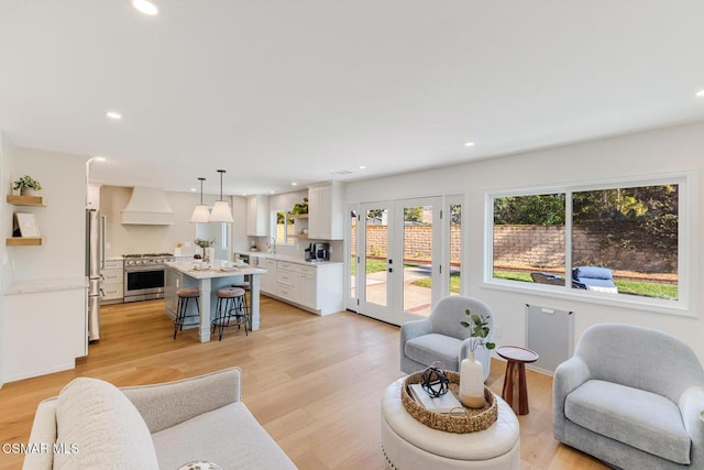 living room with light hardwood / wood-style floors and french doors