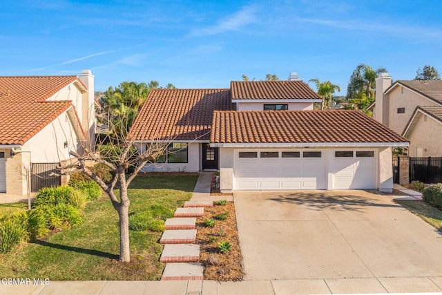 mediterranean / spanish house featuring a garage and a front lawn