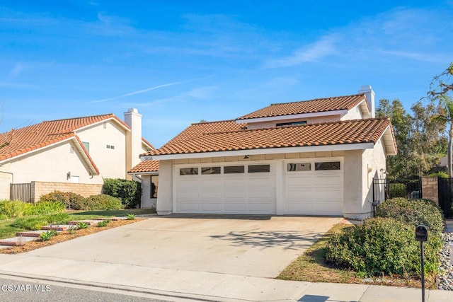 mediterranean / spanish-style house with a garage