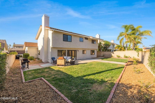 back of property featuring an outdoor living space, a yard, and a patio