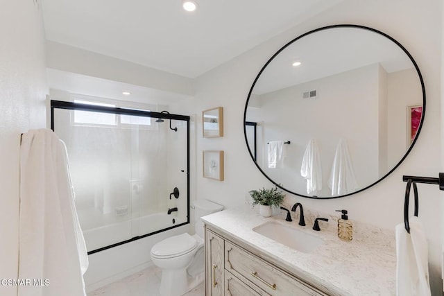 full bathroom with vanity, enclosed tub / shower combo, and toilet