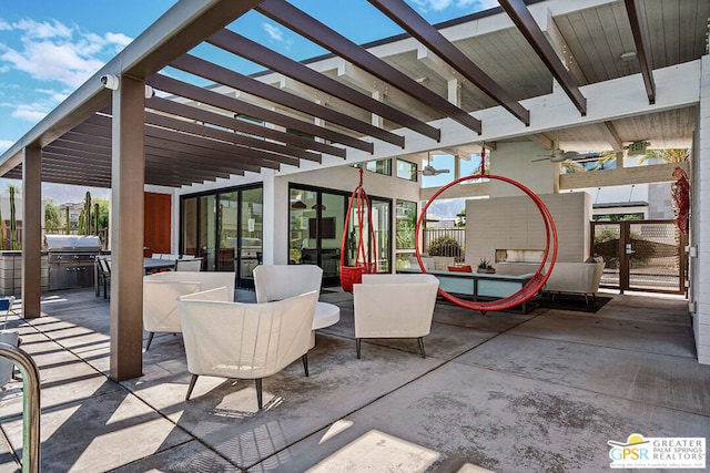 view of patio / terrace featuring area for grilling, ceiling fan, and a pergola