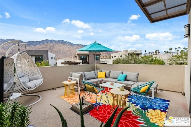 view of patio featuring a balcony, a mountain view, and outdoor lounge area