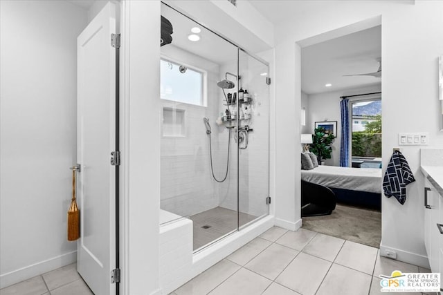 bathroom with vanity, a shower with door, plenty of natural light, and tile patterned floors