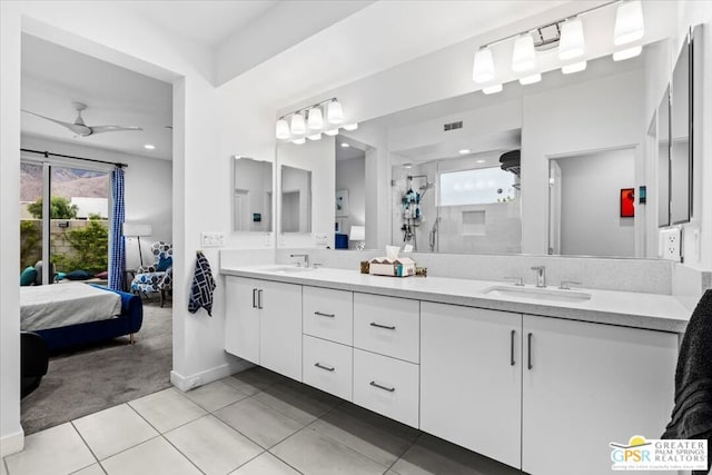 bathroom with walk in shower, vanity, tile patterned flooring, and a wealth of natural light