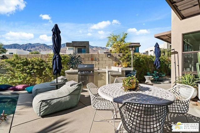 view of patio / terrace featuring area for grilling and a mountain view