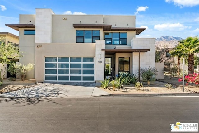 modern home with a mountain view and a garage