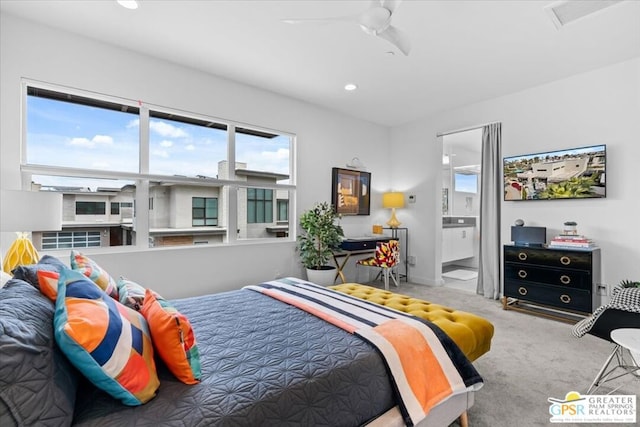 bedroom featuring light colored carpet and connected bathroom