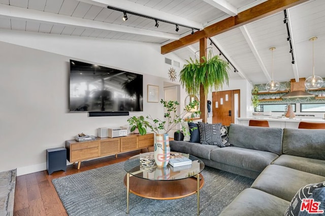 living room with lofted ceiling with beams, track lighting, and dark hardwood / wood-style flooring