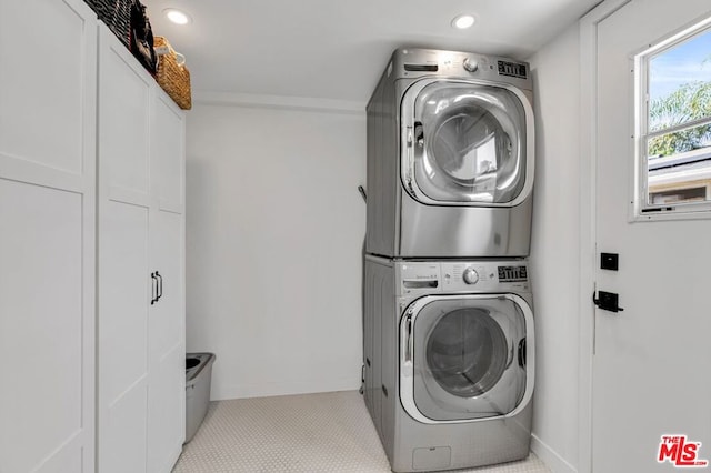 laundry area with stacked washer / drying machine