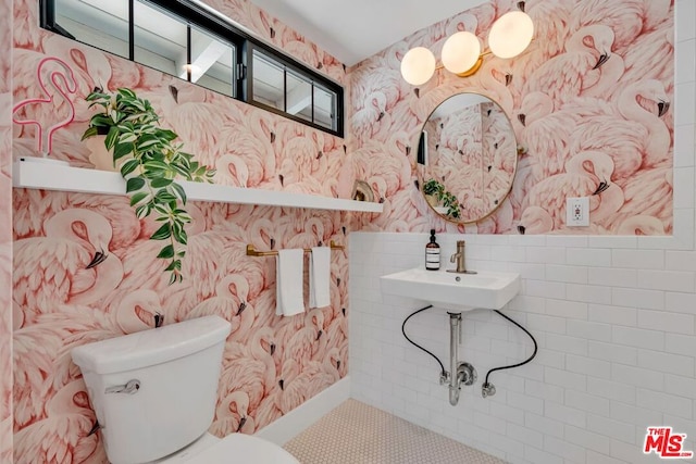 bathroom featuring tile patterned floors, toilet, and sink