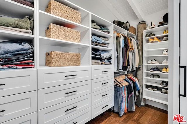 walk in closet with dark hardwood / wood-style flooring and vaulted ceiling with beams