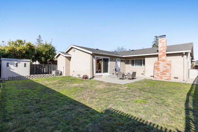 back of property featuring a shed, cooling unit, a yard, and a patio area