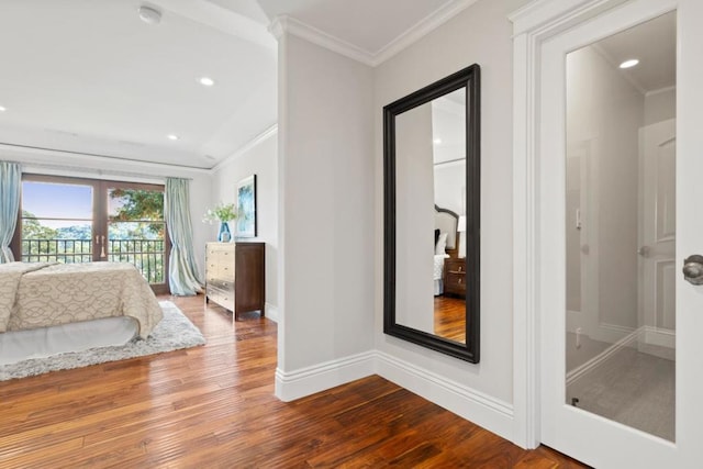 bedroom with ornamental molding, hardwood / wood-style floors, access to exterior, and french doors