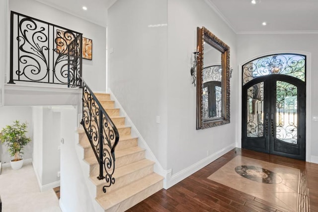 entryway featuring french doors, ornamental molding, and wood-type flooring