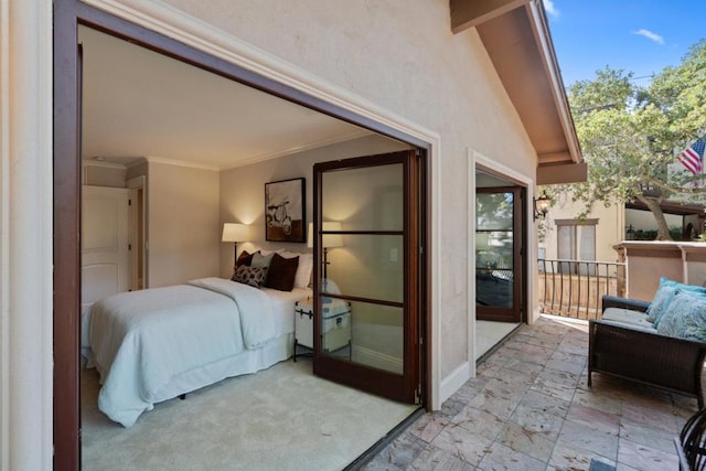 bedroom with crown molding and lofted ceiling