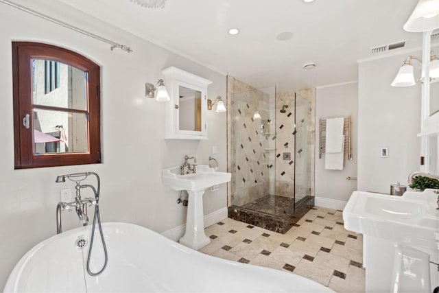 bathroom featuring double sink and independent shower and bath