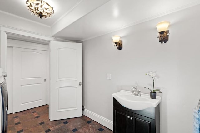 bathroom with vanity, washer and clothes dryer, and ornamental molding