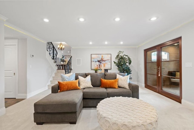 living room featuring french doors, light colored carpet, ornamental molding, and a notable chandelier