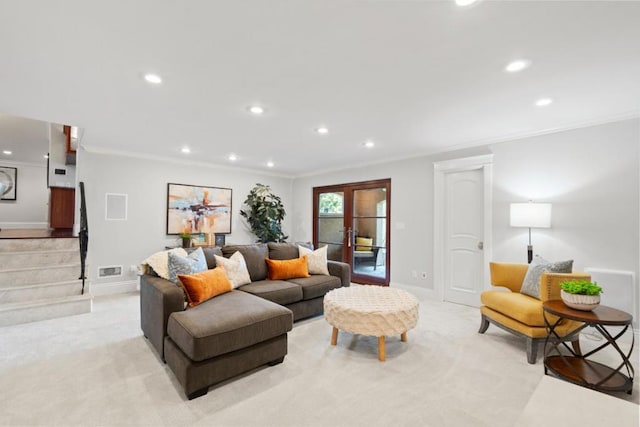 carpeted living room with crown molding and french doors