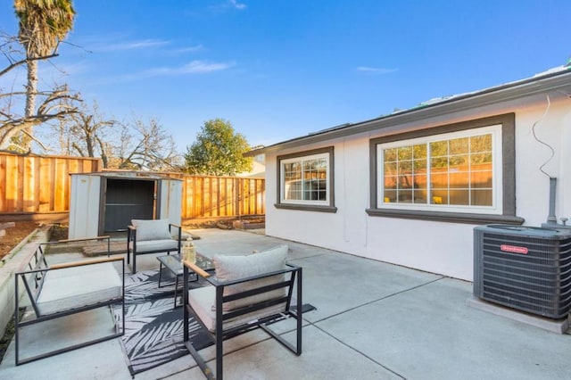 view of patio featuring an outdoor living space, central AC unit, and a shed